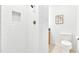 Bright bathroom with white tiled shower and patterned flooring at 102 Lake Dr, Wendell, NC 27591