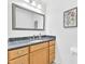 Bathroom featuring granite counters, wood cabinets, and a large vanity mirror at 102 Lake Dr, Wendell, NC 27591