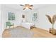 Cozy bedroom with lots of natural light, hardwood flooring, and a ceiling fan at 102 Lake Dr, Wendell, NC 27591