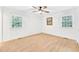 Empty bedroom with hardwood flooring, bright windows, and a ceiling fan at 102 Lake Dr, Wendell, NC 27591
