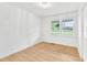 Simple bedroom with hardwood flooring, bright windows, and a chandelier at 102 Lake Dr, Wendell, NC 27591