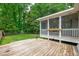 Large wooden deck with view of backyard, white railing, string lights and flower boxes at 102 Lake Dr, Wendell, NC 27591