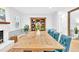 Bright dining room with wooden table, blue chairs and hardwood floors at 102 Lake Dr, Wendell, NC 27591