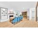 Open dining area with brick fireplace, and unique wooden table and blue chairs at 102 Lake Dr, Wendell, NC 27591