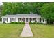 Charming brick home with a well-manicured lawn and inviting front porch at 102 Lake Dr, Wendell, NC 27591