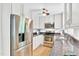 Bright kitchen featuring stainless steel appliances, granite countertops, and wood flooring at 102 Lake Dr, Wendell, NC 27591