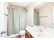 Neutral bathroom featuring a shower-tub combo and vanity with dark wood, providing a clean and functional space at 1028 Summerhouse Rd, Cary, NC 27519