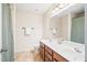 Well-lit bathroom featuring double sinks, a spacious countertop, and ample storage for a convenient and organized space at 1028 Summerhouse Rd, Cary, NC 27519