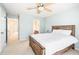 Relaxing bedroom featuring a wooden bed frame, ceiling fan, and serene paint color, creating a comfortable retreat at 1028 Summerhouse Rd, Cary, NC 27519