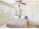 Bright bedroom with built-in shelving, closet space, and a large window, offering ample storage and natural light at 1028 Summerhouse Rd, Cary, NC 27519