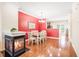 Inviting dining room featuring a cozy fireplace, elegant chandelier, and an adjacent kitchen area for seamless entertaining at 1028 Summerhouse Rd, Cary, NC 27519