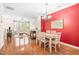 Open-concept dining area with a table for four and a view into the living room at 1028 Summerhouse Rd, Cary, NC 27519