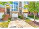 Brick townhome with garage, green yard, and a welcoming entrance at 1028 Summerhouse Rd, Cary, NC 27519