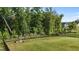 Expansive backyard with lush green grass and a black metal fence, offering privacy and space at 1042 Cardross St, Burlington, NC 27215