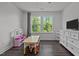 A bright bedroom featuring two large windows and dark wood floors at 1042 Cardross St, Burlington, NC 27215