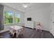 A bright bedroom featuring two large windows and dark wood floors at 1042 Cardross St, Burlington, NC 27215