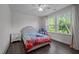 A bright bedroom featuring two large windows and dark wood floors at 1042 Cardross St, Burlington, NC 27215