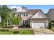 Beautiful home featuring a two-car garage, manicured lawn, and welcoming front porch at 1042 Cardross St, Burlington, NC 27215