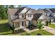 Charming two-story home with a welcoming front porch and well-manicured lawn at 1042 Cardross St, Burlington, NC 27215