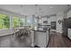 Bright eat-in kitchen with pendant lighting, modern appliances, and dark wood flooring at 1042 Cardross St, Burlington, NC 27215