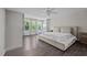 Bright main bedroom with large windows, ceiling fan, and dark wood flooring at 1042 Cardross St, Burlington, NC 27215