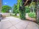 Spacious backyard featuring a pergola covered in vines and a large concrete patio for entertaining at 10436 Cokesbury Ln, Raleigh, NC 27614