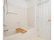 Bright bathroom featuring a bathtub with grab bars and a wooden bath tray at 10436 Cokesbury Ln, Raleigh, NC 27614