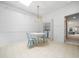 Bright dining area with skylight, featuring a modern chandelier, a table with blue chairs, and a washer/dryer at 10436 Cokesbury Ln, Raleigh, NC 27614
