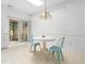 Bright dining area featuring a round table, blue chairs, and a sliding door to an outdoor area at 10436 Cokesbury Ln, Raleigh, NC 27614