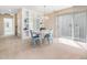 Light-filled dining room with modern chandelier, light blue chairs, and sliding glass doors at 10436 Cokesbury Ln, Raleigh, NC 27614