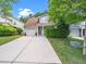 Inviting home with attached garage, lush landscaping, and a spacious driveway at 10436 Cokesbury Ln, Raleigh, NC 27614