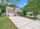 Charming home with a well-manicured lawn, mature trees, and a long driveway at 10436 Cokesbury Ln, Raleigh, NC 27614