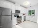 Well-lit kitchen featuring stainless steel appliances, white cabinetry, and ample counter space for cooking and meal prep at 10436 Cokesbury Ln, Raleigh, NC 27614