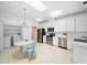 Spacious kitchen with stainless steel appliances, white cabinets, a skylight, and an adjacent dining area at 10436 Cokesbury Ln, Raleigh, NC 27614