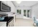 Bright kitchen with white cabinets, stainless steel appliances, and sliding glass doors to the backyard at 10436 Cokesbury Ln, Raleigh, NC 27614