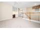 Spacious living area with built-in desk and shelving, complemented by a staircase and natural light at 10436 Cokesbury Ln, Raleigh, NC 27614