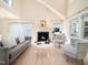Cozy living room with a fireplace, comfortable seating, and ample natural light at 10436 Cokesbury Ln, Raleigh, NC 27614