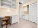 Cozy office featuring built-in shelving, a desk, and a mini refrigerator for added convenience at 10436 Cokesbury Ln, Raleigh, NC 27614