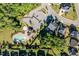 Aerial shot showcasing a community pool, clubhouse, parking, landscaping, and nearby homes in a residential neighborhood at 105 Blue Prince Trl, Holly Springs, NC 27540