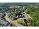 Aerial view of a densely populated suburban neighborhood featuring numerous homes, green spaces, and community amenities at 105 Blue Prince Trl, Holly Springs, NC 27540