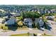 Aerial view of a neighborhood showcasing houses, green lawns, and mature trees in a well-maintained community at 105 Blue Prince Trl, Holly Springs, NC 27540