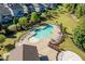 Aerial view showcasing community pool, lounge chairs, and landscaping for relaxation and recreation at 105 Blue Prince Trl, Holly Springs, NC 27540