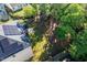 Aerial view of a backyard with tall trees, a privacy fence and solar panels on the home at 105 Blue Prince Trl, Holly Springs, NC 27540