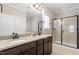 Granite counters accent the dual sink vanity and a glass enclosed shower with tile surround at 105 Blue Prince Trl, Holly Springs, NC 27540