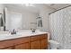 Bathroom with double sink vanity, modern faucets, and a shower with a patterned curtain at 105 Blue Prince Trl, Holly Springs, NC 27540