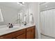 Bathroom boasts dual sinks, wooden cabinets, and a shower with a white curtain at 105 Blue Prince Trl, Holly Springs, NC 27540