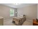 Bedroom with neutral decor, window with blinds, carpeted floor, and closet at 105 Blue Prince Trl, Holly Springs, NC 27540