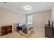 Cozy bedroom with neutral walls, carpet, and a well-lit window for a bright and inviting atmosphere at 105 Blue Prince Trl, Holly Springs, NC 27540