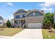 Lovely two-story home featuring a manicured front lawn, a covered porch, and stone accents at 105 Blue Prince Trl, Holly Springs, NC 27540