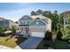 Beautiful home with stone accents, a charming front porch, and a well-manicured front lawn at 105 Blue Prince Trl, Holly Springs, NC 27540